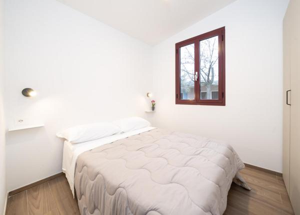 Simple room with double bed and window.